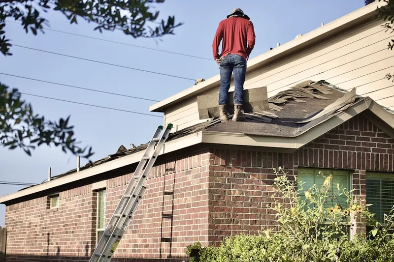 Professional roofer working on a residential roof in New Concord